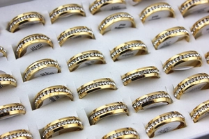 Macro view of gold plated stainless steel rings with a single row of sparkling diamonds