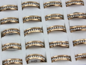 Rows of rose gold plated eternity rings with white crystals in a foam display tray