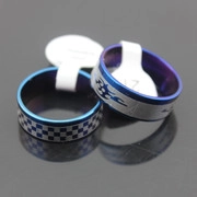 Detail view of retro silver metal rings with blue inner coating and flame engraving