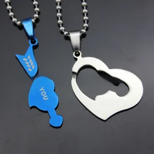 Close-up of interlocking arrow and heart couple necklaces in blue and silver steel