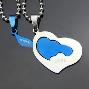 Detail of stainless steel heart and arrow couple necklace with engraved LOVE YOU text