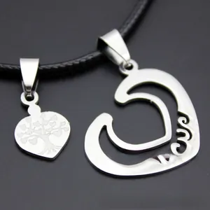 Macro shot of stainless steel heart necklace with tree of life and Love engraving