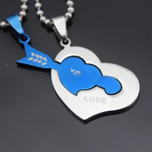 Macro detail of stainless steel puzzle necklace showing arrow and heart interlocking charms