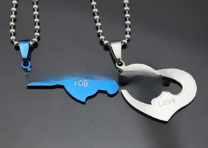 Detail view of interlocking heart and arrow necklaces with LOVE YOU engraved text