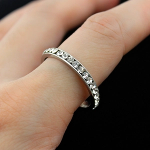 Close-up of eternity ring with row of round cubic zirconia in silver-tone metal