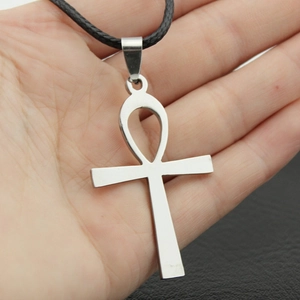 Polished stainless steel Ankh cross pendant necklace with black cord held in hand