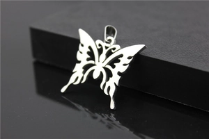 Close-up of polished stainless steel butterfly pendant with elegant hollowed-out pattern