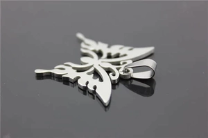 Detailed close-up of a hollow butterfly pendant made of polished silver stainless steel