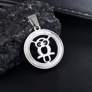 Polished stainless steel owl pendant necklace with shell detail on black rock background