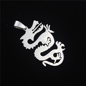 Mens stainless steel hollow dragon pendant necklace in silver finish on black surface