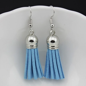 Detail of light blue faux suede tassel earrings with polished silver metal hook and cap