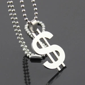 Macro shot of polished stainless steel US dollar sign pendant on a silver ball chain