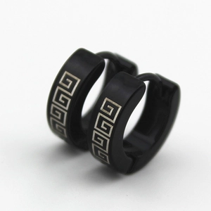 Detailed close-up of black stainless steel hoop earrings with silver meander Greek pattern
