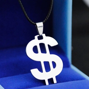 Polished stainless steel dollar sign pendant on a black cord necklace in a gift box
