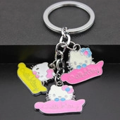 Detailed macro view of metal Hello Kitty enamel pendants on silver keychain rings