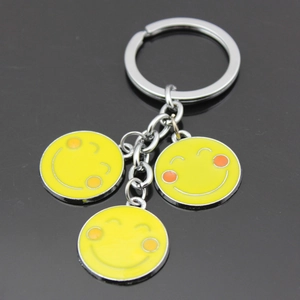 Creative silver metal keychain with three yellow smiling face pendants for men and women