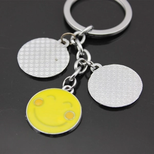 Creative metal keychain with a yellow smiley face charm and silver round pendants
