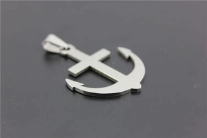 Detailed view of a silver polished stainless steel anchor cross pendant with metal texture