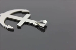 Polished silver anchor pendant detail in stainless steel with a metallic reflective finish