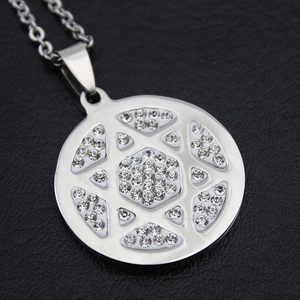 Macro shot of silver hexagram pendant with clear zircons on black leather