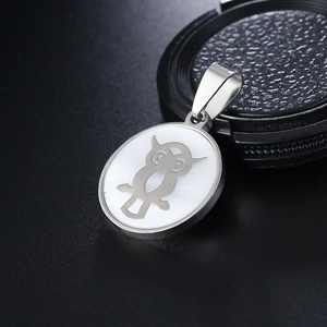 Fashionable stainless steel owl pendant necklace with white shell inlay on a black surface