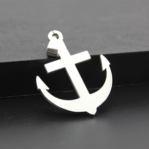 Polished stainless steel anchor cross pendant on a black textured stand for men and women