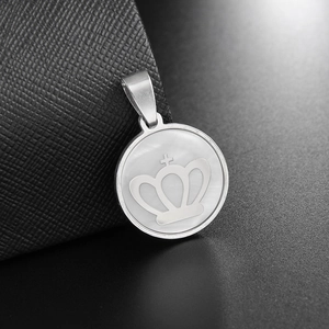 Stainless steel necklace with shell inlay and crown engraving on a dark texture