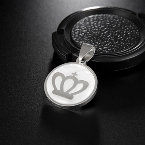Stainless steel round shell necklace with grey crown pendant on black textured background