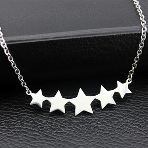 Polished stainless steel necklace featuring five star pendants on a delicate cross chain