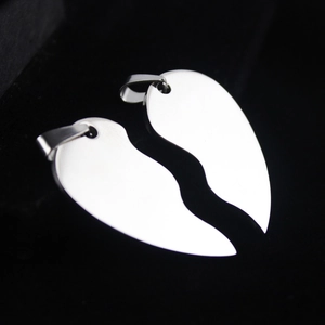 Polished stainless steel heart puzzle pendant necklace set for couples on black background