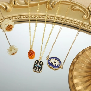 Exquisite Evil Eye heart necklaces on golden chain with vintage mirror reflection
