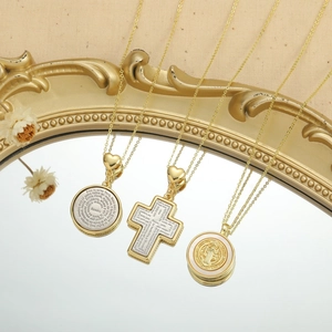 Golden religious cross and shell coin pendant necklaces for women over beige background