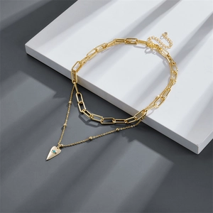 Golden double-layered paperclip chain necklace with heart and blue evil eye pendant