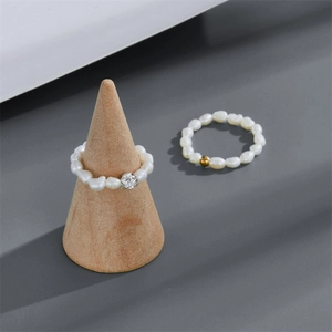 French Baroque freshwater pearl rings set with 14k gold beads on minimalist wood stand