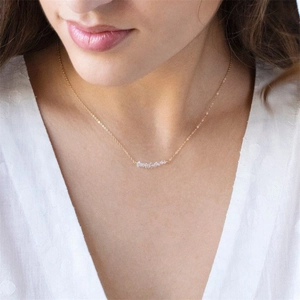Detailed view of a 14K gold-plated necklace featuring clear natural stone crystal pendants