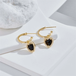 Elegant gold heart earrings with black gems and white zircon on bamboo texture hoops