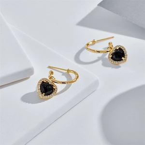 Elegant gold heart-shaped earrings featuring black faceted stones and zircon border