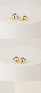 Macro detail of 14k gold plated brass earrings featuring a row of inlaid white zircons
