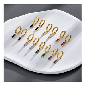 Close-up of gold-plated hoop earrings with rectangular zircon crystals in seven vibrant colors