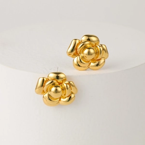 Classic French camellia stud earrings in polished gold finish on white display stand