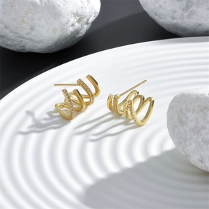 Detailed macro view of S925 sterling silver stamp on 18k gold plated claw stud earrings