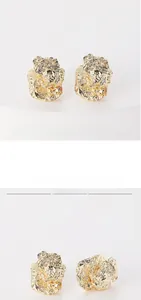 Detailed macro view showing the unique textured gold plating on irregular stud earrings