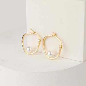 Minimalist U-shaped 14K gold plated hoop earrings featuring elegant white freshwater pearls