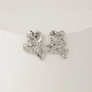 Irregular silver textured stud earrings with abstract molten lava metal design