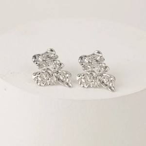 Modern silver metallic earrings with abstract crumpled texture and irregular artistic design