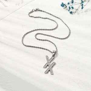 Hypoallergenic double X pendant necklace with sparkling cubic zirconia on twist chain
