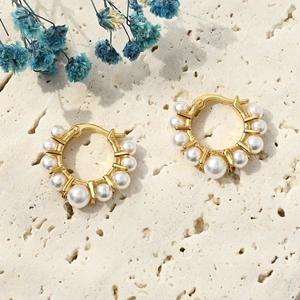 Elegant 14k gold plated hoop earrings with white freshwater pearls on a stone base