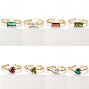 Assorted gold butterfly rings with heart and rectangle crystals in various colors
