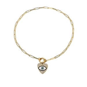 Golden paperclip chain necklace with zircon evil eye heart pendant in a minimalist style