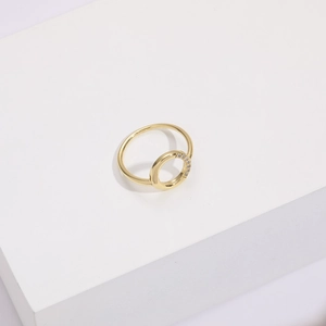 Detailed macro view of 14k gold plated round ring with sparkling zircon inlay